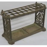 A VICTORIAN CAST IRON STICK STAND with twenty four circular divisions, above a pair of drip trays