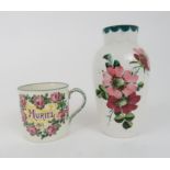 A WEMYSS MUG decorated with the name Muriel and date 1911 within a cartouche of pink roses, with a