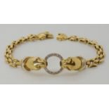 AN 18CT GOLD LEOPARD BRACELET the two leopards are holding a diamond set ring in their mouths and