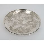 A CHINESE SILVER CIRCULAR TRAY decorated with a dragon chasing the flaming pearl, within a pierced