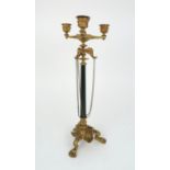 A GILDED METAL CANDELABRA the four candle sconces above three elephant head terminals, the claw foot