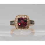 A 14K LE VIAN ROSE GOLD DIAMOND AND RHODOLITE RING signed Le Vian, the diamonds are grain set to the