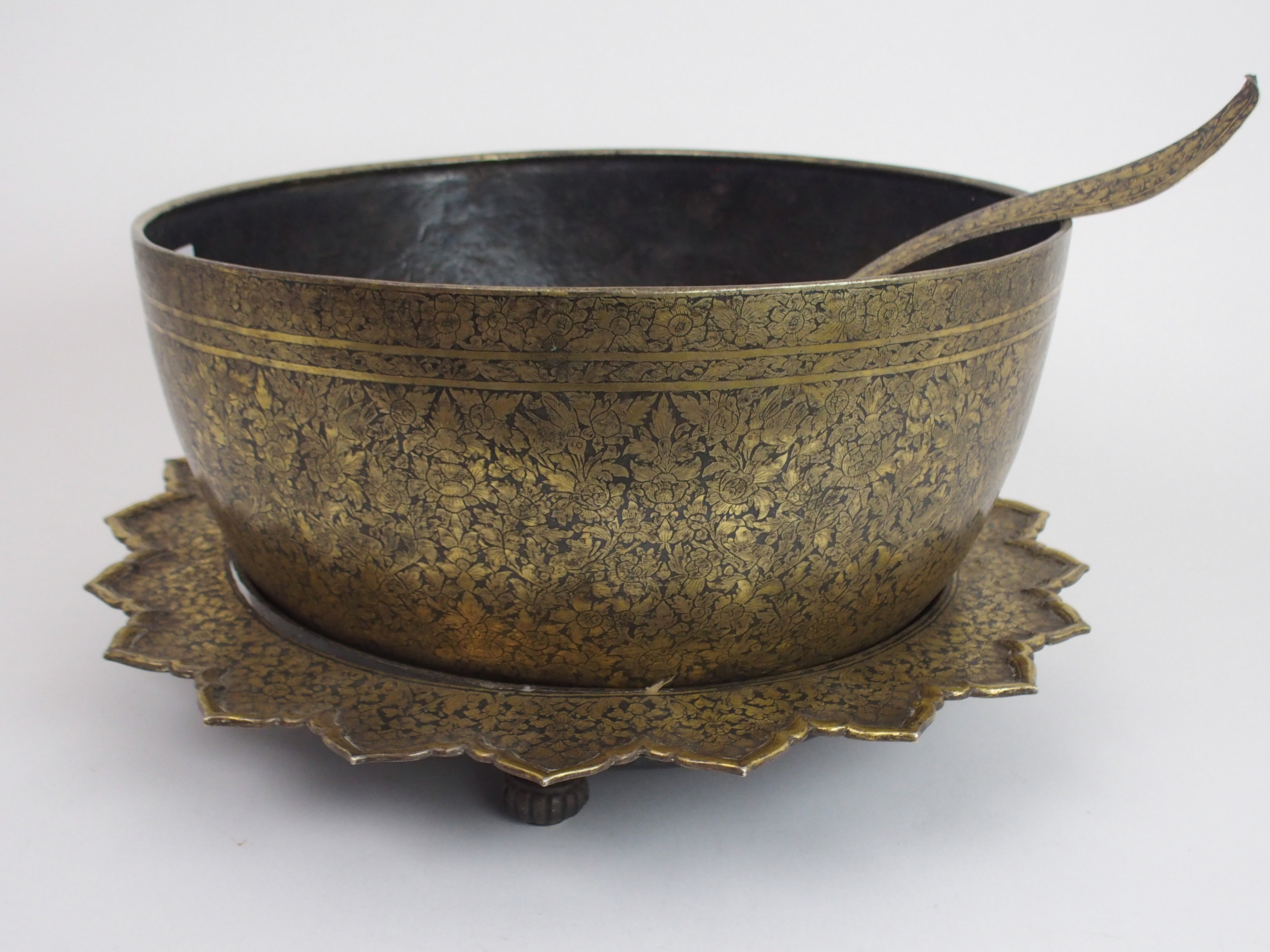 A SIAMESE/THAI GILT NIELLO BOWL, STAND AND LADLE profusely decorated with animals and foliage, the