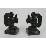 MAX LE VERRIER (1891-1973) A PAIR OF LARGE PATINATED METAL SQUIRREL BOOKENDS on black green veined