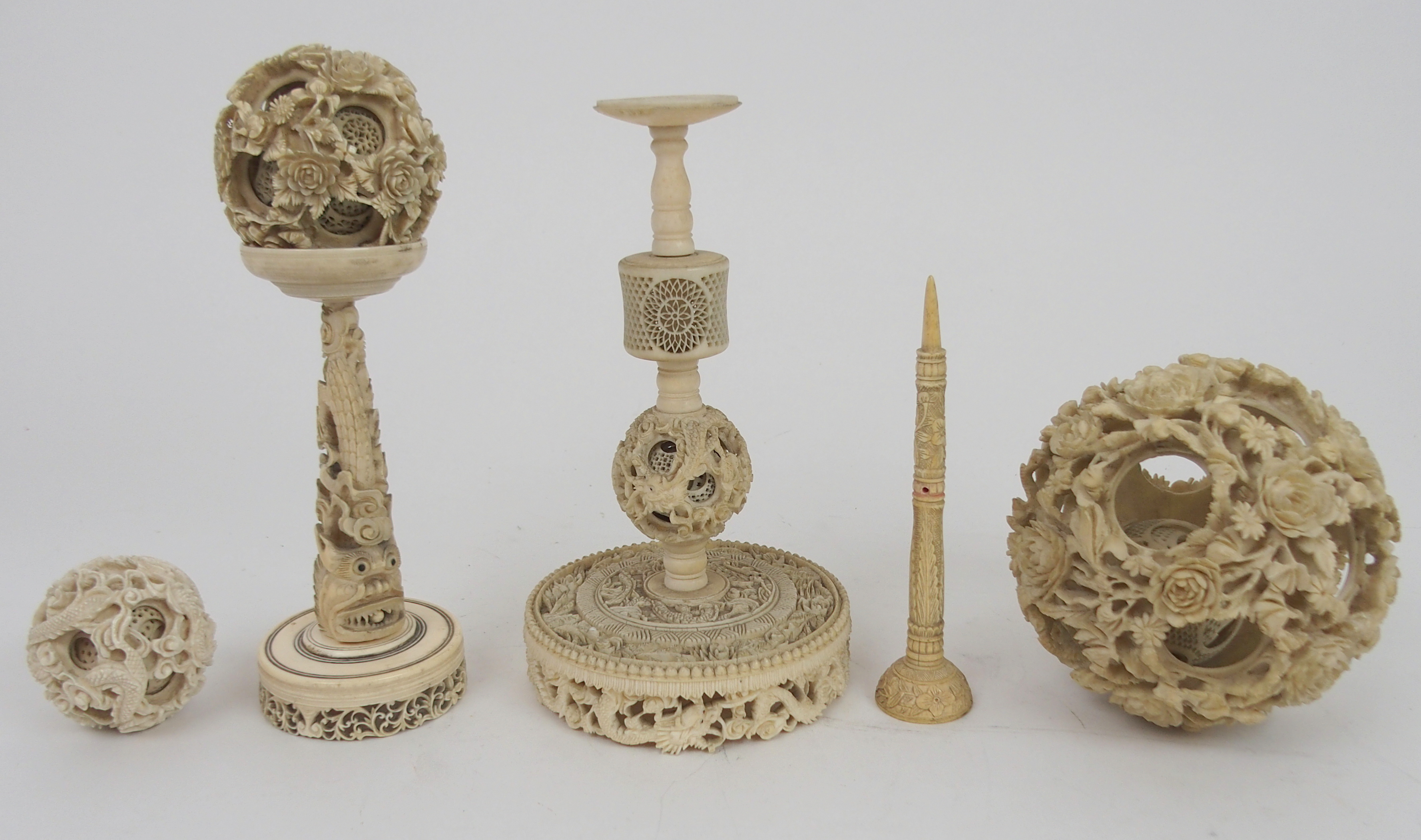 A CHINESE IVORY CONCENTRIC BALL AND A STAND 21.5cm high, a ball carved with foliage, 12cm