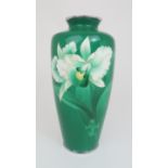 A JAPANESE CLOISONNE BALUSTER VASE decorated with an iris on a green ground, with white metal