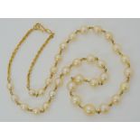 A YELLOW METAL LINKED PEARL NECKLACE largest pearl 9mm, smallest 5.6mm, length of necklace 49cm,