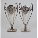A PAIR OF CHINESE SILVER TWO HANDLED VASES decorated with pierced and chased foliage, stamped marks,