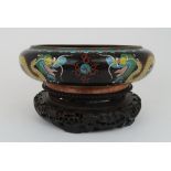 A CHINESE CLOISONNE BOWL decorated with a dragon surroundin the flaming pearl on a cloud ground, the