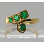AN EMERALD DRESS RING mounted in bright yellow metal, the four good quality emeralds, are both