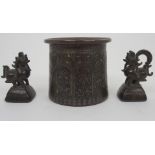 AN INDIAN BRONZE VASE cast with panels of deities within arched niches and within stiff leaf