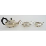 A THREE PIECE SILVER TEA SERVICE by Deakin & Francis Birmingham 1922 of octagonal form the faceted