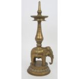 AN INDIAN BRASS ELEPHANT PRICKET CANDLESTICK modelled and cast in two parts, the animal supporting a