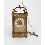 A FRENCH R & CO BRASS AND GLASS CARRIAGE CLOCK the burnished gilt front panel with enamelled chapter