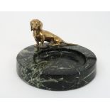 A BRONZE MODEL OF A DACHSHUND mounted on a green veined marble dish base, 17cm diameter Condition