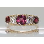 AN 18CT GOLD GARNET AND DIAMOND CLUSTER RING the two old cut diamonds of estimated approx 0.40cts