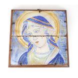 A 19TH CENTURY STYLE TIN GLAZED TILE OF THE MADONNA in two parts, framed and held in with iron