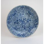 A CHINESE BLUE AND WHITE CIRCULAR DISH painted with scrolling peonies and foliage, 38cm diameter