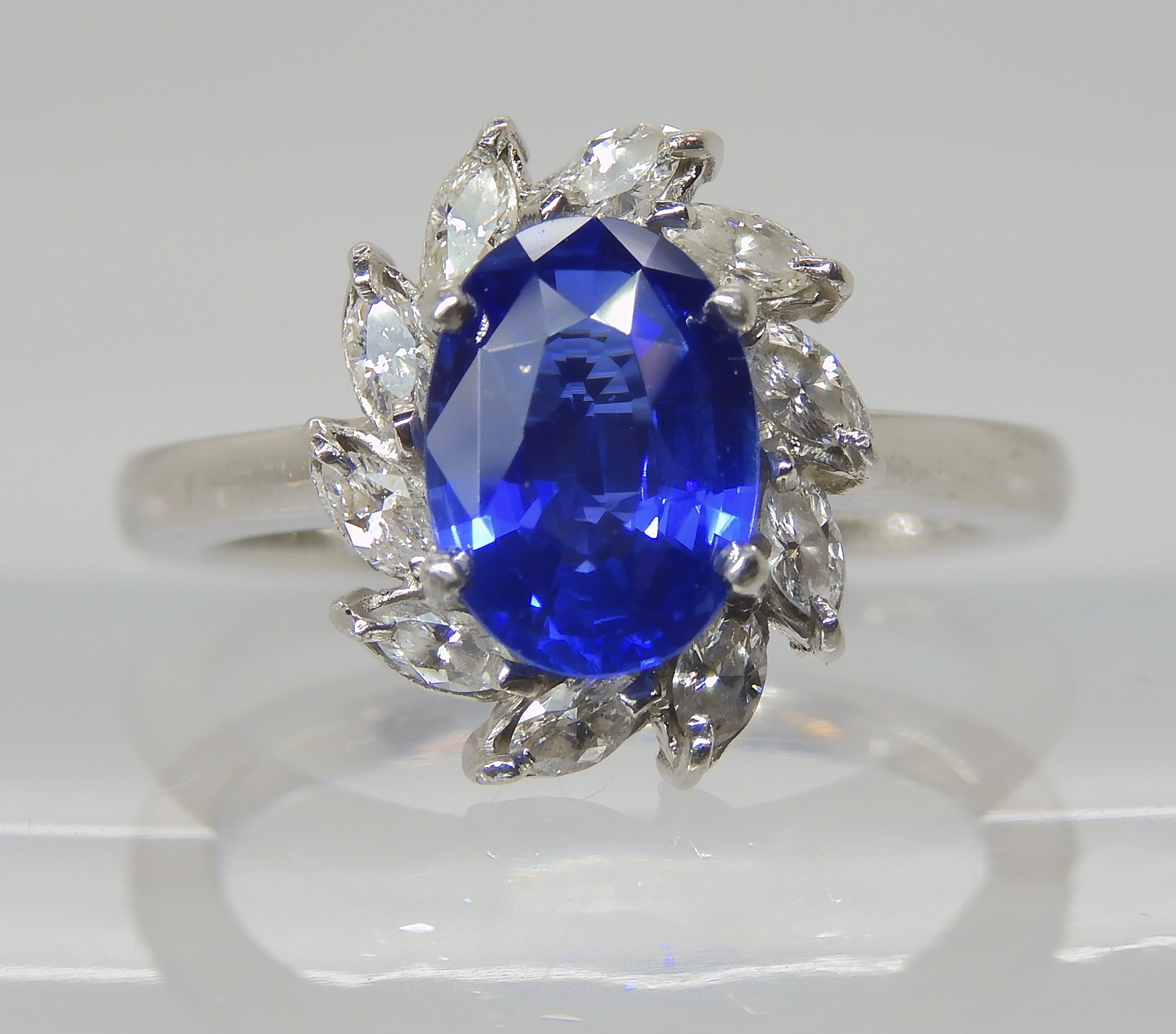 A PLATINUM SAPPHIRE AND DIAMOND RING made by Blair & Sheridan, the 8.2 x 5.9 x 3.5mm sapphire is
