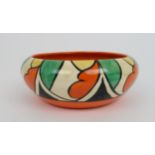 A CLARICE CLIFF DOUBLE V PATTERN BOWL decorated with geometric designs in black, orange, green and
