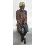 A GOLDSCHEIDER LIFE SIZE FIGURE OF A SMILING AFRICAN AMERICAN BOY modelled seated with crossed