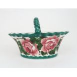 A WEMYSS BASKET of oval shape, painted with cabbage roses, with twisted handle, impressed mark and