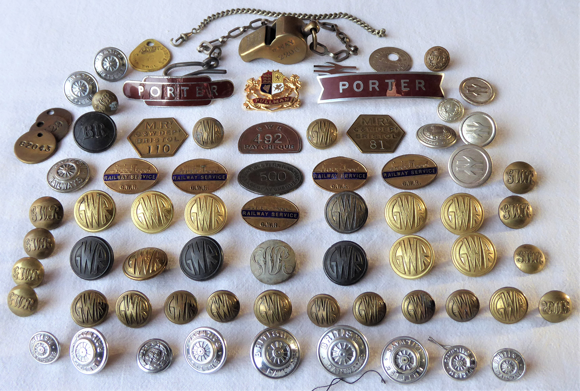 A collection of GWR. LMS and BR Buttons, WW2 Service Badges. GWR P way 2200 Guards whistle. 2 x