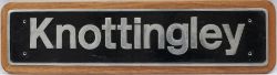 Nameplate KNOTTINGLEY - Uncarried and mounted on wooden back board. The original nameplate was