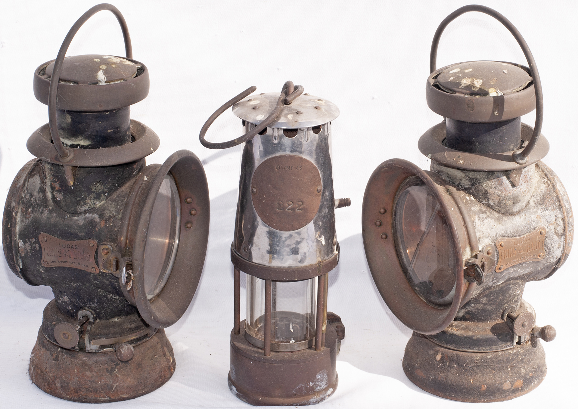 A pair of LUCUS KING OF THE ROAD Vehicle oil lamps together with a miners safety lamp.