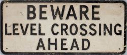 Road sign BEWARE LEVEL CROSSING AHEAD measuring 22in x 9.5in. Cast aluminium in as removed