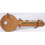 Advertising display sign in the shape of a large yale key with YALE KEYS STOCKED HERE . Cast