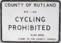 Road sign COUNTY OF RUTLAND BYE-LAW CYCLING PROHIBITED ALAN BOND CLERK OF JUSTICE measuring 18in x