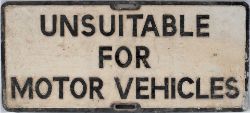 Road sign UNSUITABLE FOR MOTOR VEHICLES measuring 29.25in x 13.25in. Cast aluminium in as removed