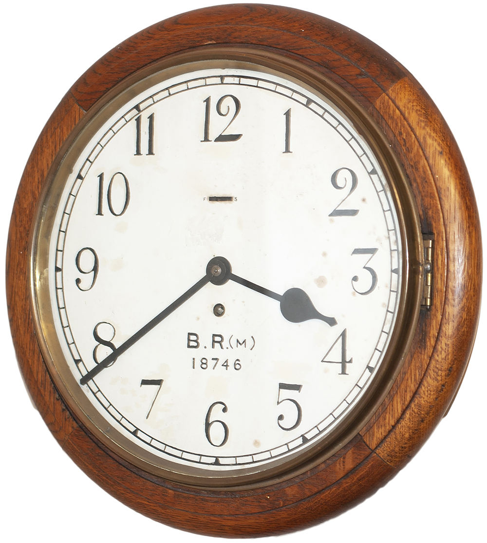 BR(M) 12 inch oak cased railway clock with Smiths going barrel movement. The original dial has