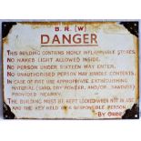 BR(W) Enamel sign. DANGER. THIS BUILDING CONTAINS HIGHLY INFLAMMABLE STORES. Measures 14 x 10 in.