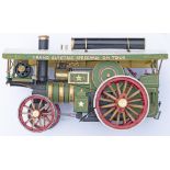 A painted model of a Showman's Traction Engine. Slight damage to top of glass case.