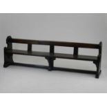 A 19th century joined oak pew, of plain bench type with shaped sides and moulded top rail, 214cm