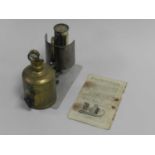 A Mita Lilliput Reford light with wing nut pressure valve and gauge above a brass fuel chamber,