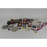 A large collection of metal and cloth shooting medals