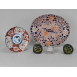 An assembled group of Japanese and Chinese ceramics and enamels, including a lobed oval Imari