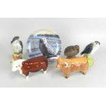 Beswick models of a Highland Bull and a Hereford Bull together with two Royal Doulton Peregrine
