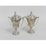 A near pair of silver trophy cups and covers