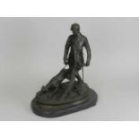 A modern bronze figure group of huntsman and hound on a black marble base, 44cm high overall.