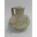 An Egyptian pottery beer or water vessel, New Kingdom (1550-1070 BC), of onion form with broad strap