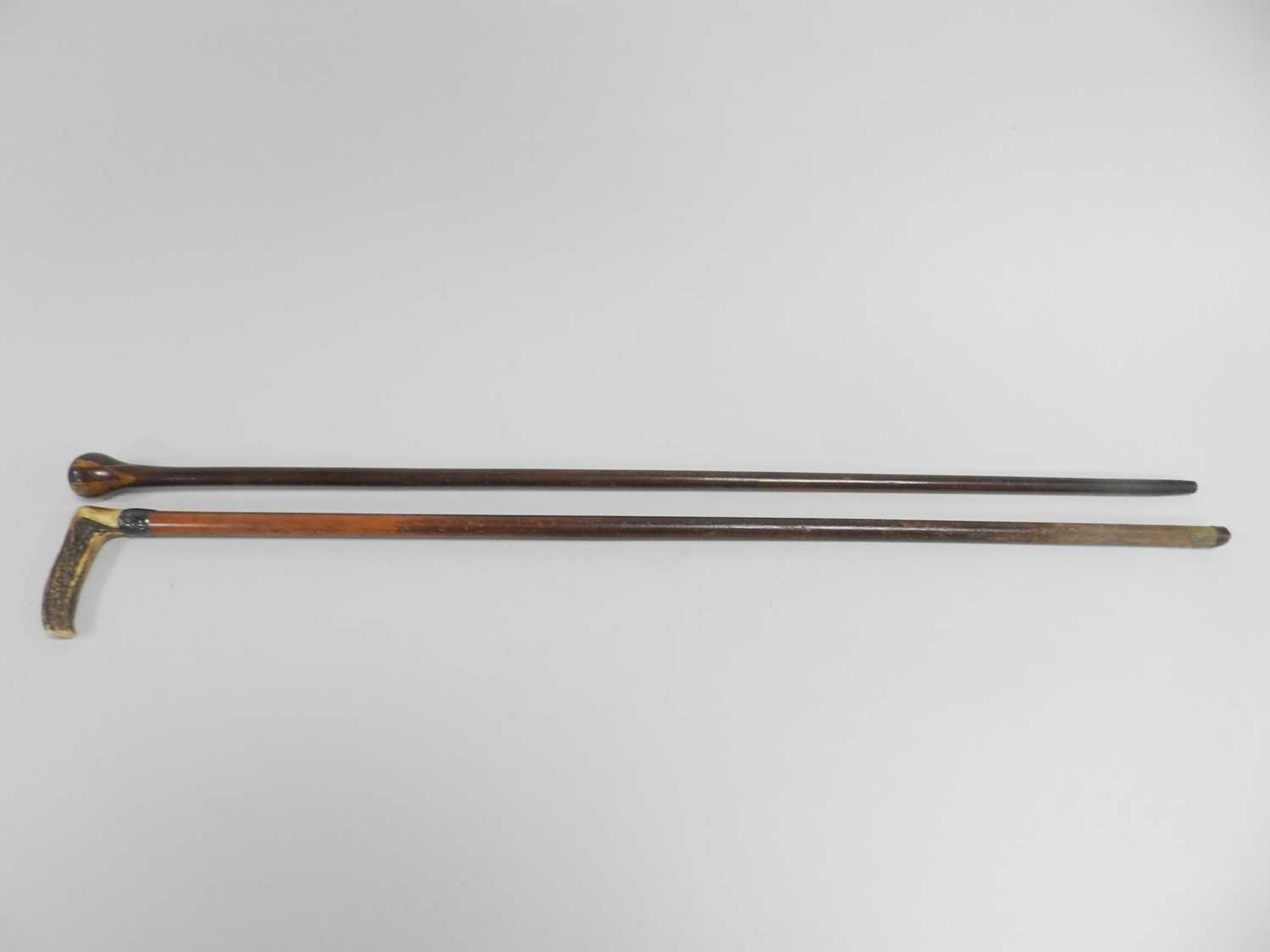 A horn-handled cane, with silver collar on a tapering birch cane, 89cm long, together with an inlaid