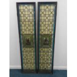 A pair of framed full-height leaded glass doors in the Renaissance style with amber bull eye centres