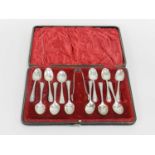 A cased part set of teaspoons and sugar tongs