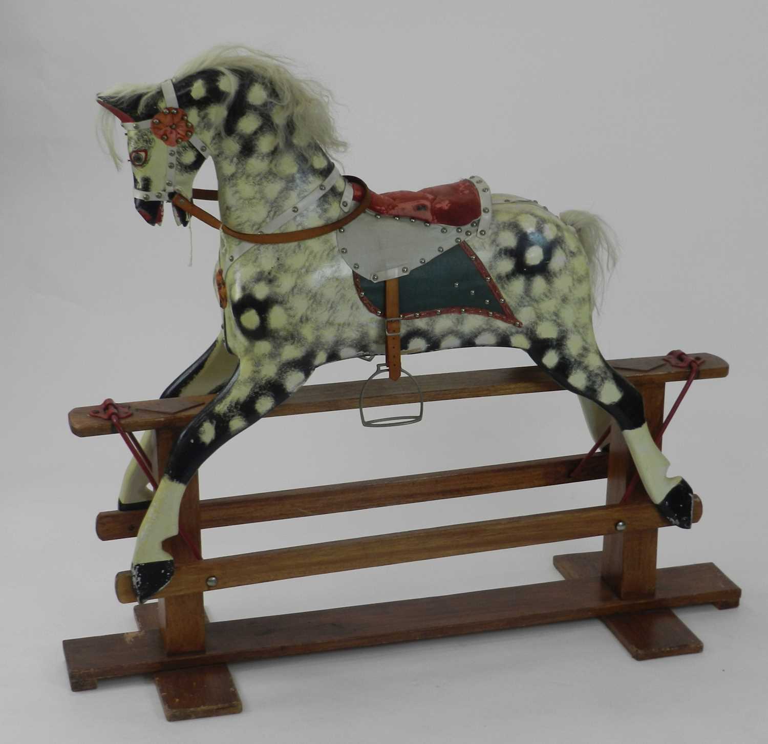 A British painted wood rocking horse, in dappled grey colour, with faux leather tack and upholstered