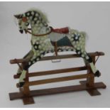 A British painted wood rocking horse, in dappled grey colour, with faux leather tack and upholstered