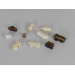 A group of small Chinese and other carved bone and tigers eye animal figures and beads, circa